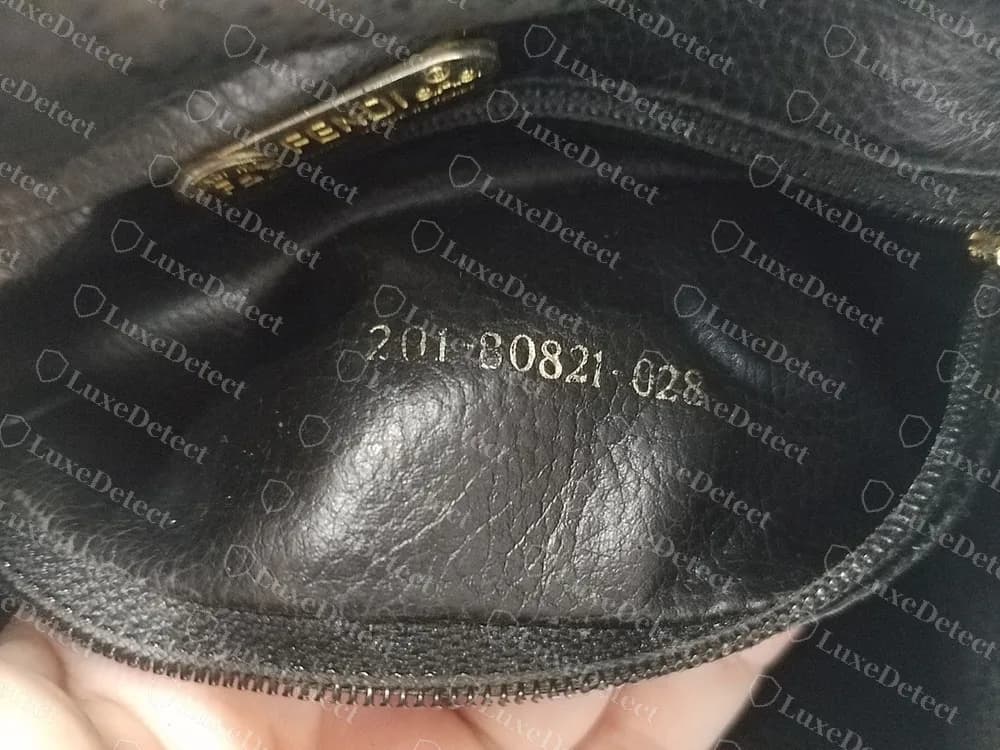 A genuine vintage Fendi drawstring bucket bag with a short code stamped in the zip pocket lining: 201-80821-028