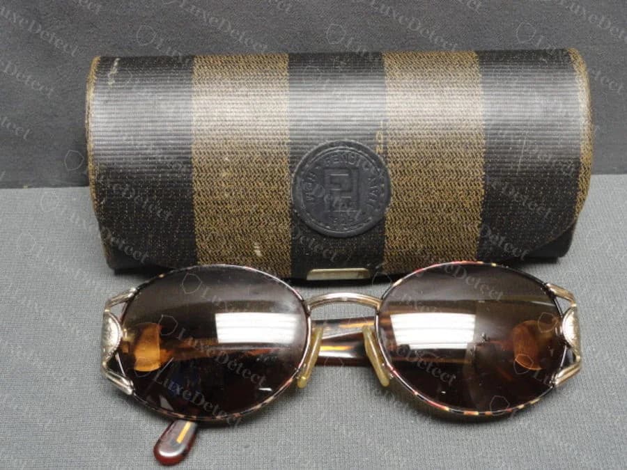 Counterfeit Fendi pair with a vintage-style pequin-stripe hard case stamped with the "FENDI ROMA ITALY 1925" medallion.