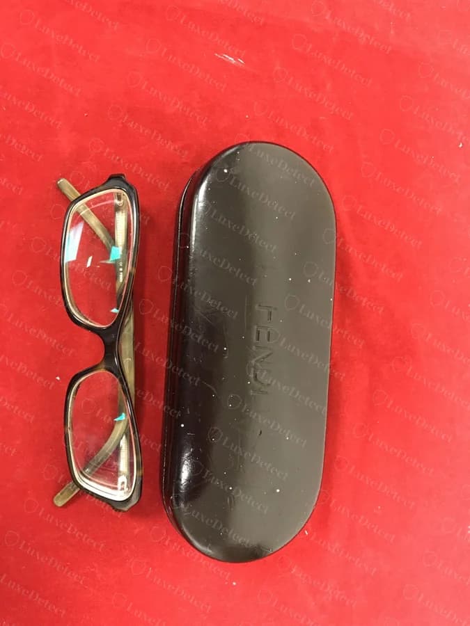 Authenticated Fendi eyeglasses with a modern embossed black leather case carrying a tonal "FENDI" wordmark, no medallion.