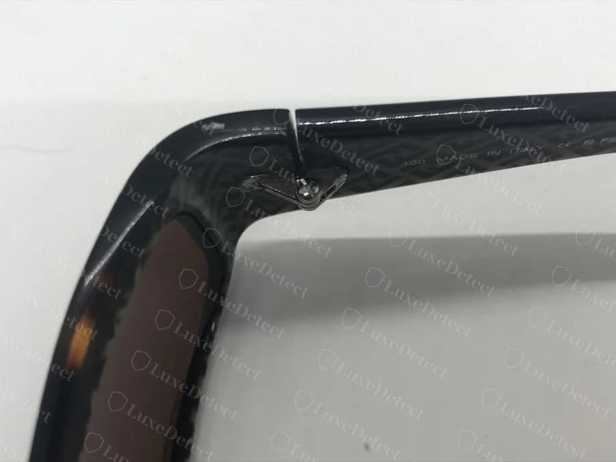 Authenticated Fendi frame showing the zucca (FF monogram) pattern printed on the inside of the acetate temple, with a separate enamel FF hardware tab near the hinge.