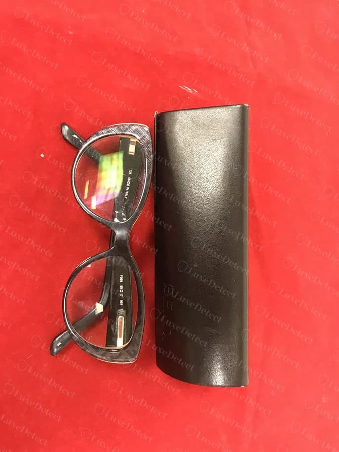 Authenticated Fendi eyeglasses next to their embossed leather case, showing the printed temple code and "MADE IN ITALY" text.