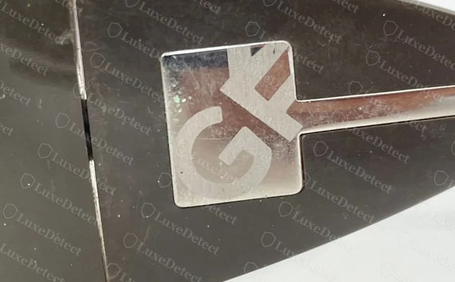 Genuine Ferré sunglasses: square silver-tone plaque on the dark brown temple, carrying the letters G and F joined as a monogram