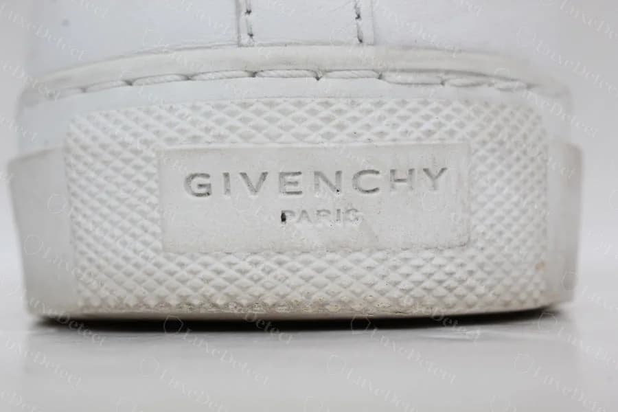 Genuine Givenchy Urban Street rubber heel patch with a raised GIVENCHY PARIS plate on a textured block