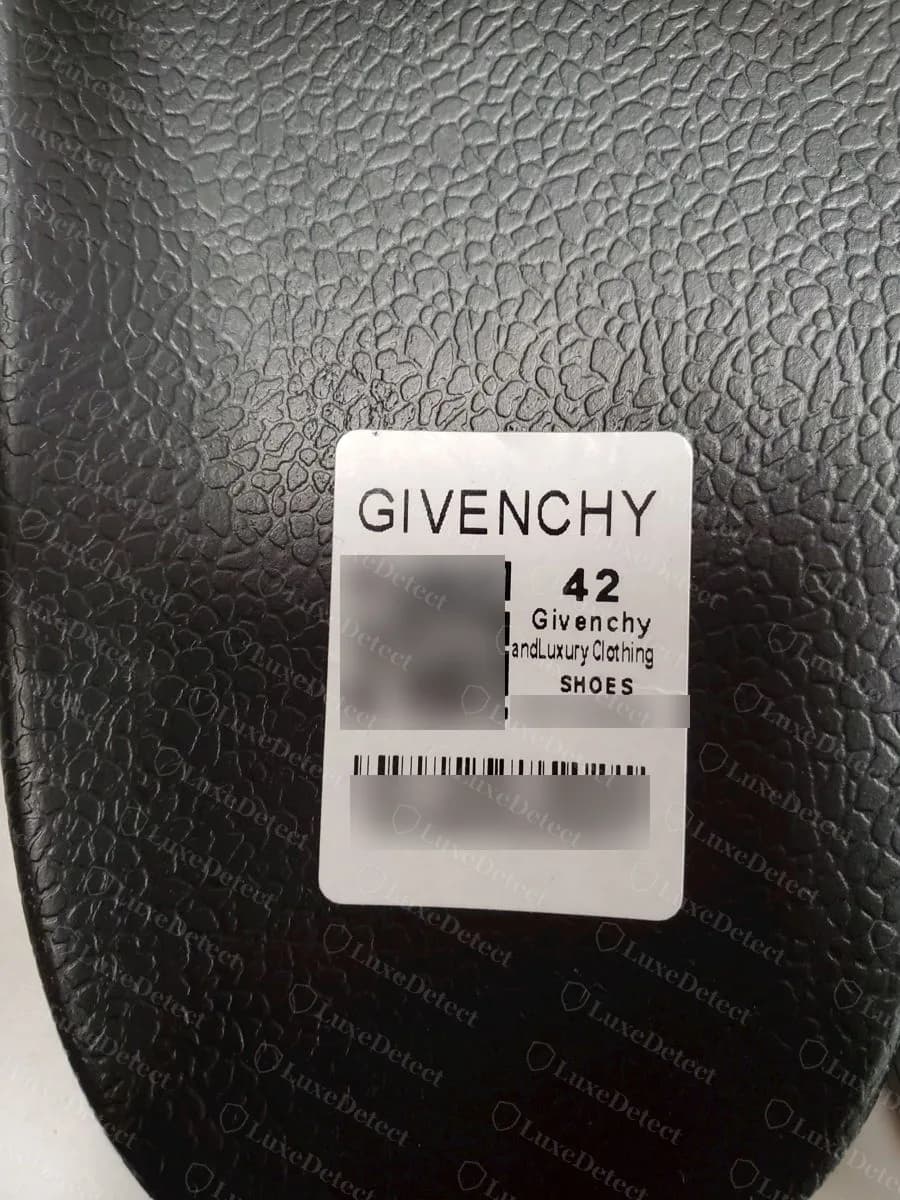 Slide Givenchy falsa con una etiqueta blanca en la suela que dice Givenchy andLuxury Clothing y la talla 42, códigos de barras difuminados