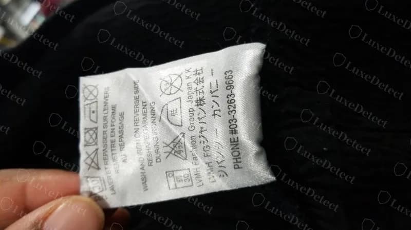 Counterfeit Givenchy distressed hoodie care label on the same template: "LVMH FG ジャパン", the ジバンシー カンパニー line and the same wrong phone number, 03-3263-9663.