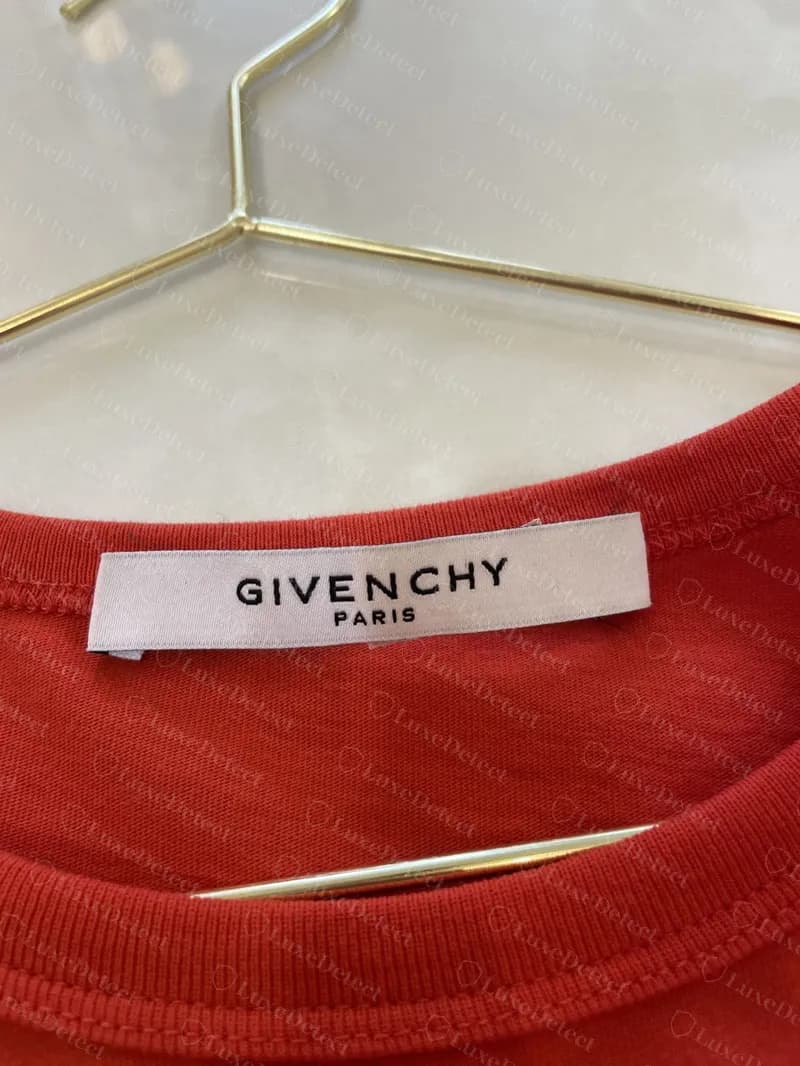 Genuine Givenchy T-shirt neck label: "GIVENCHY / PARIS" in spaced capitals on a clean white woven label.