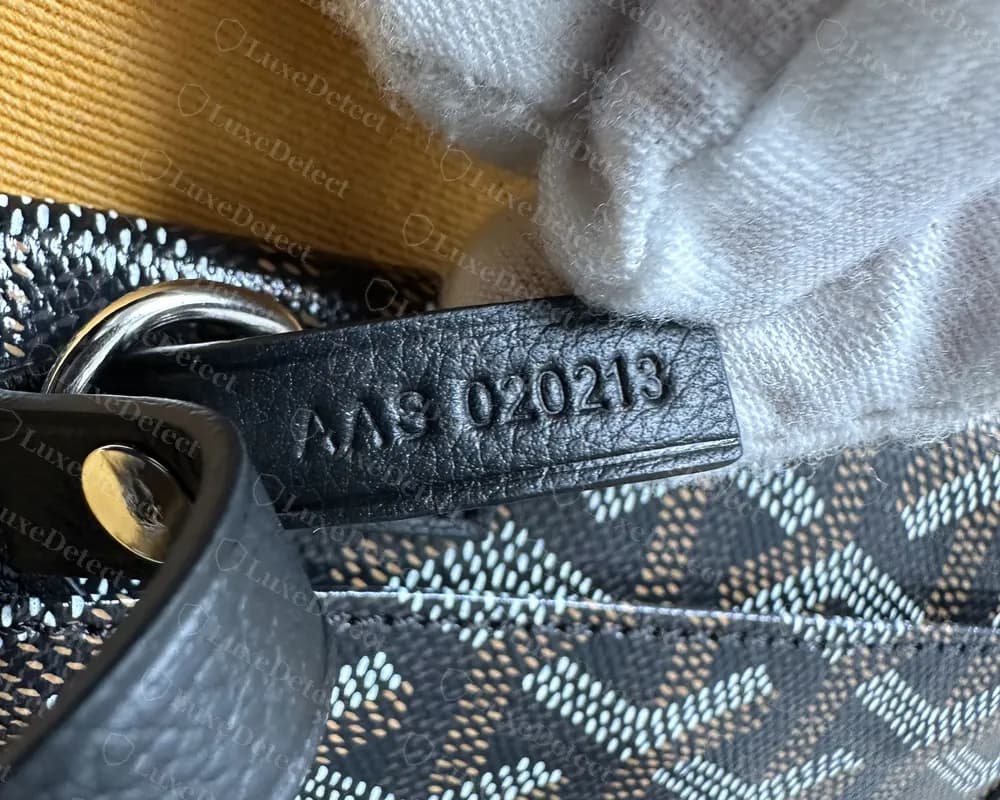 Counterfeit Goyard Anjou heat-stamped code AAS 020213 on black leather