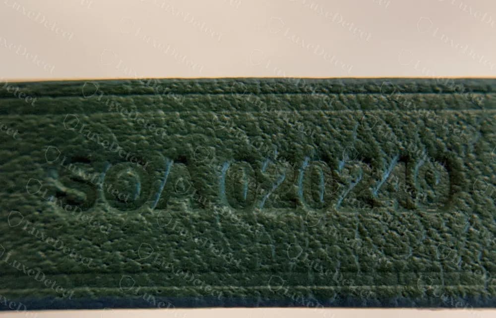 Genuine Goyard Anjou heat-stamped code on a green leather tab, reading three letters and six digits