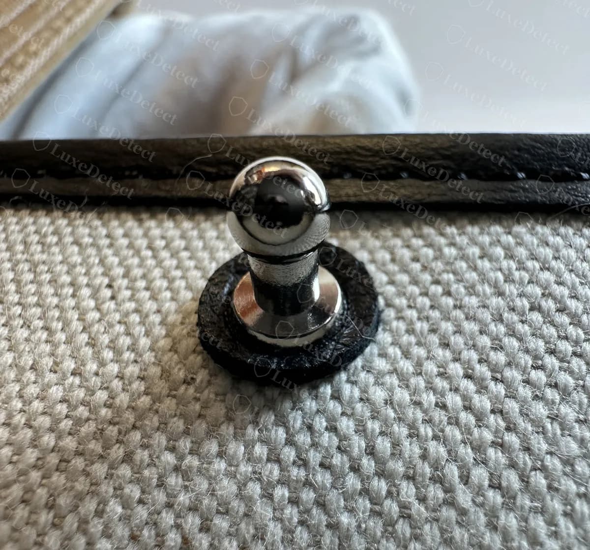 Genuine Goyard Artois push-stud set on a leather washer in the canvas lining