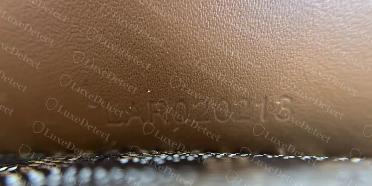 Genuine Goyard Saigon heat-stamped code reading LAR 020213 on leather just above the canvas