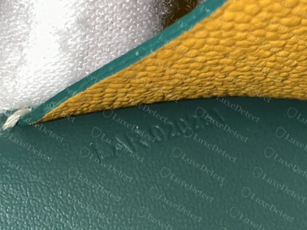 Genuine Goyard Saint-Sulpice card holder code, LAR 020251, stamped sideways into green leather inside the central pocket beside the yellow goatskin lining