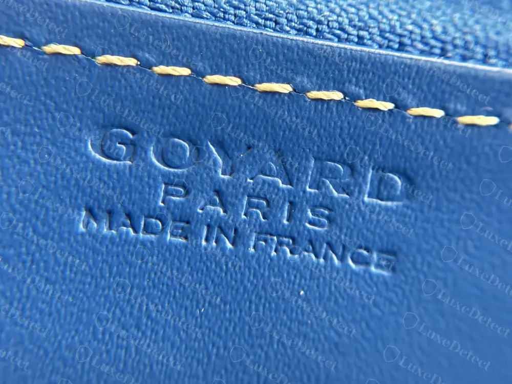 Genuine Goyard Matignon heat stamp: GOYARD, PARIS and MADE IN FRANCE in widely spaced serif capitals, pressed blind into sky-blue leather