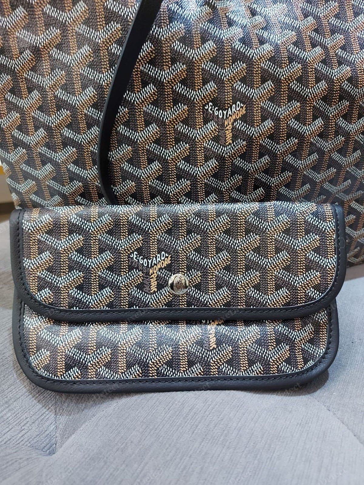 Counterfeit Goyardine — the chevron is printed, not painted: the Y elements are mechanically uniform, the address text is over-crisp and repeats too regularly, and the surface has a flat plasticky sheen with no linen texture