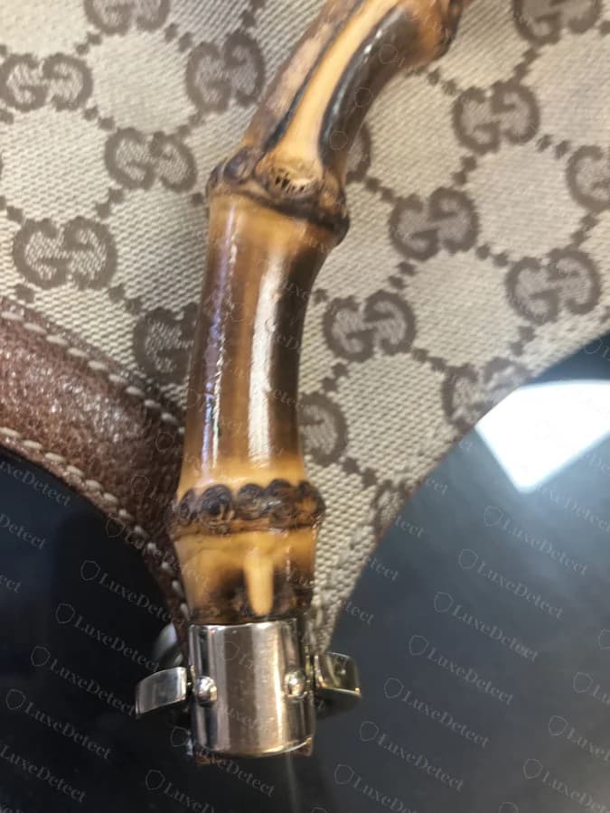 Genuine Gucci Bamboo handle, close on the node and ferrule join, honey-toned lacquer with visible natural grain and torch darkening
