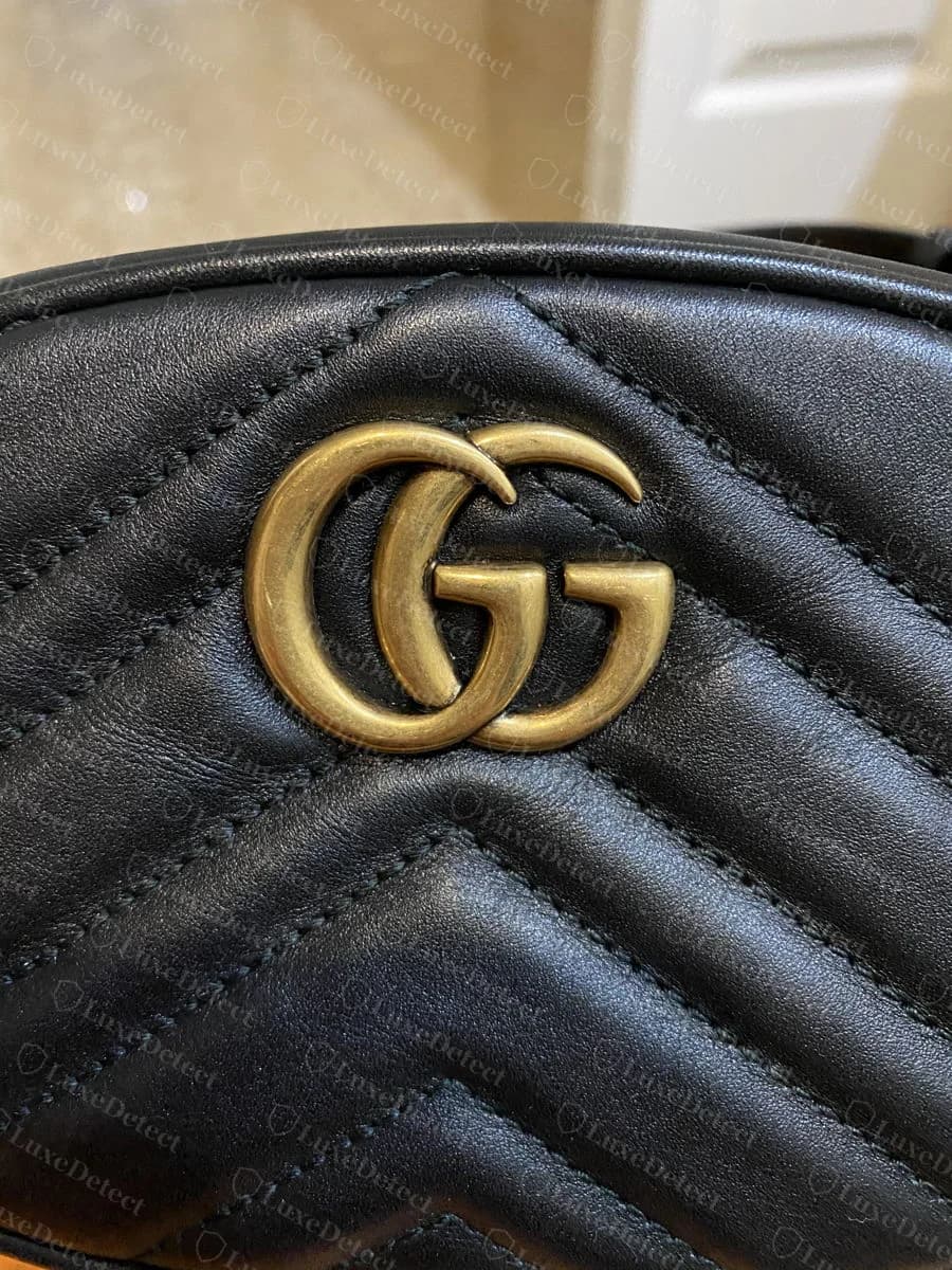 Genuine Gucci belt bag Double-G hardware on matelassé leather, gold-tone antique finish, even chevron quilting radiating from the mount point