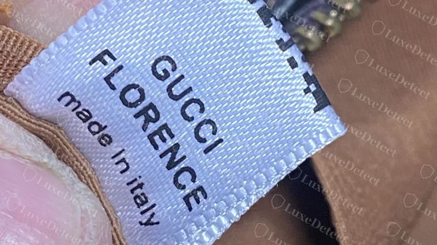 Fake bag with a white satin label reading GUCCI FLORENCE made in italy