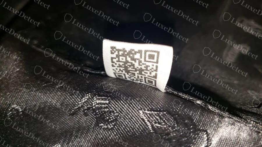 Fake bag with a white woven label carrying a large QR code