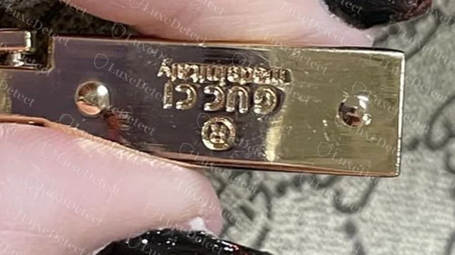 Fake zip plate with the GUCCI made in italy text running upside down relative to the ring logo