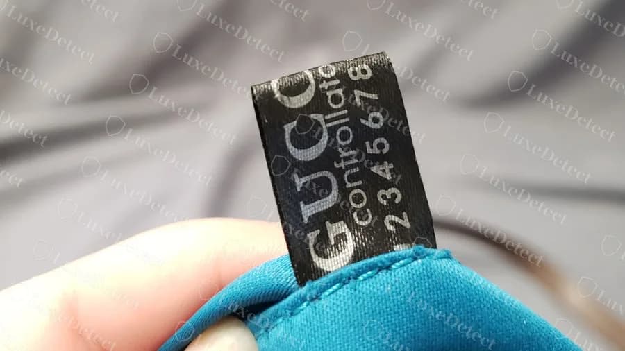 Fake interior tag reading controllato 2345678, a counting run printed on a black fabric tag
