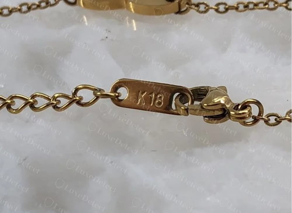 Counterfeit Gucci heart necklace with K18 stamped on the clasp tag