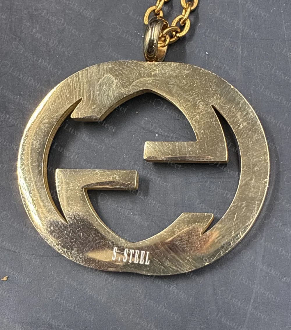 Counterfeit Interlocking G pendant stamped S.STEEL near the lower edge