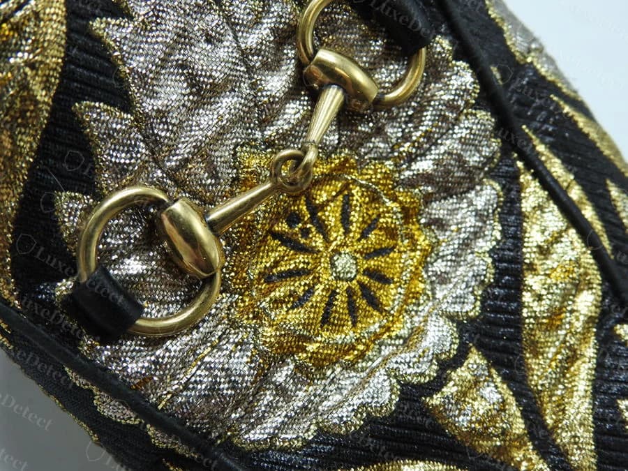 Authentic Gucci Princetown horsebit hardware on a jacquard brocade upper: single consistent gold finish, clean cast rings, seated flush in the leather keeper