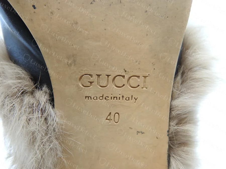 Counterfeit Gucci Princetown outsole heat stamp: "GUCCI" over "madeinitaly" run together with no spacing and no lower-case rendering, inconsistent with the same pair's correctly-stamped interior tab