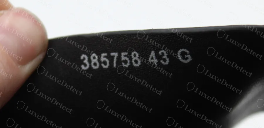 Counterfeit GG Blooms slide: 385758 43 G printed in white ink on the underside of the strap
