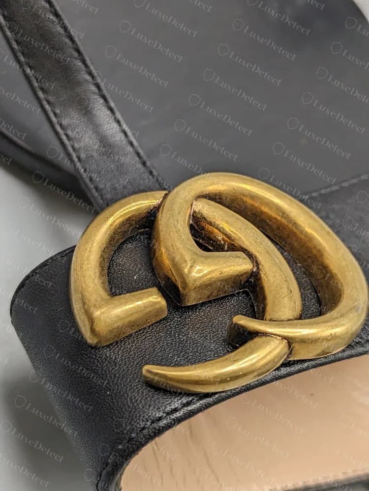 Genuine Marmont thong hardware: double-G plate with a soft antique gold finish on the black leather strap