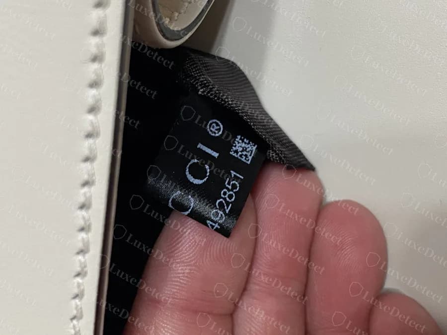 Genuine Sylvie black satin interior tag with "GUCCI", the data-matrix square and a printed code