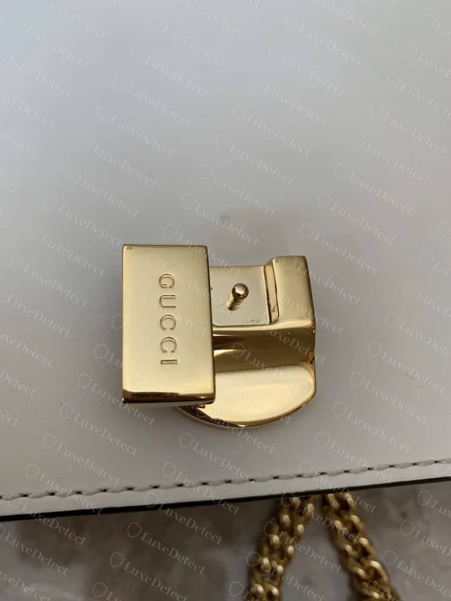 Genuine Sylvie turn-lock on the bag body under the flap, "GUCCI" engraved on the upper plate
