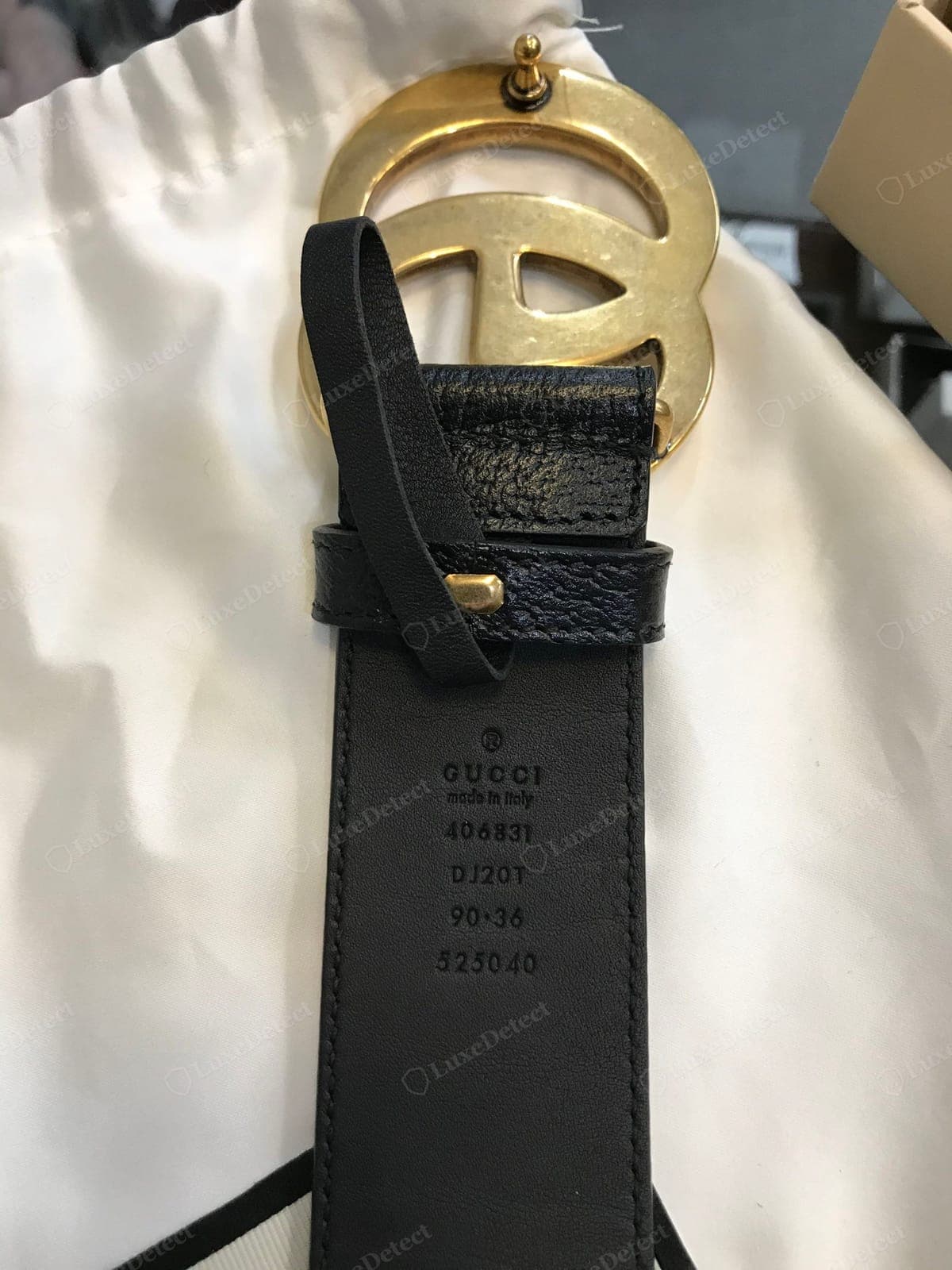 Counterfeit Gucci belt buckle reverse — casting seams or pitting, a soft or wrong-font engraving