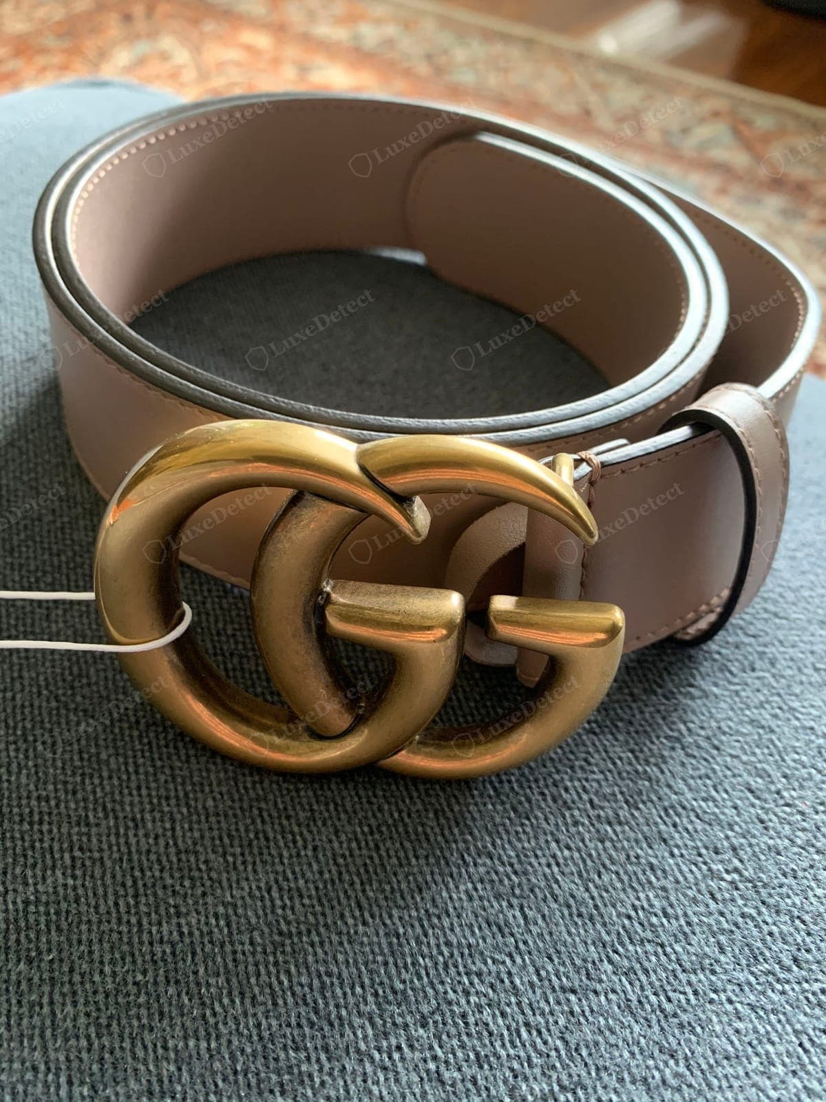 Genuine Gucci belt Double-G buckle — the two Gs interlocking cleanly, a solid weighty casting, an even antiqued finish