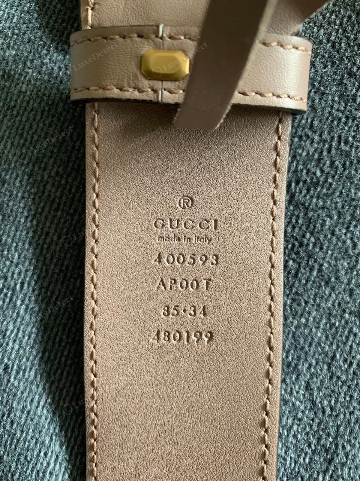 Genuine Gucci belt size stamp — the size and "made in Italy" stamped cleanly into the strap in the house font