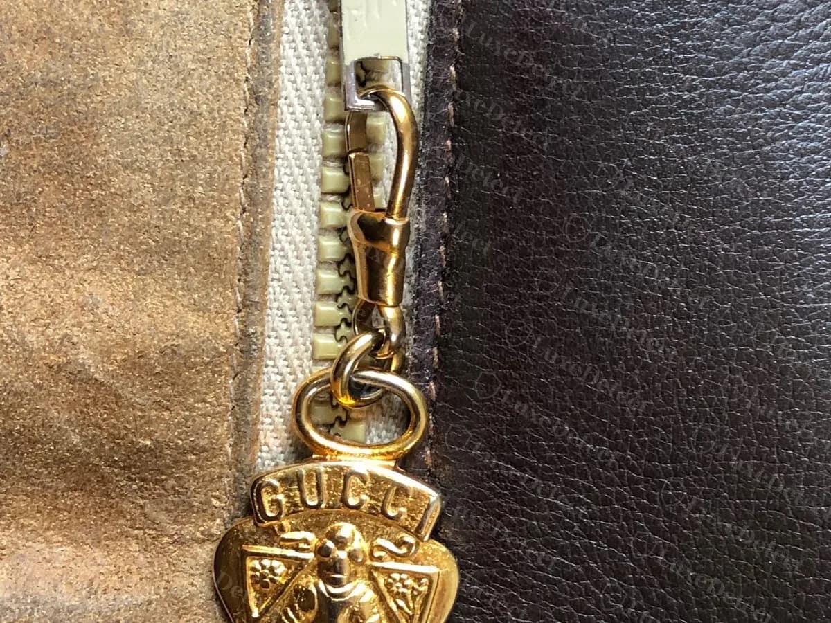 Genuine vintage Blondie interior zip with a gold-tone Gucci crest charm, a shield showing a figure and the letters GUCCI across the top