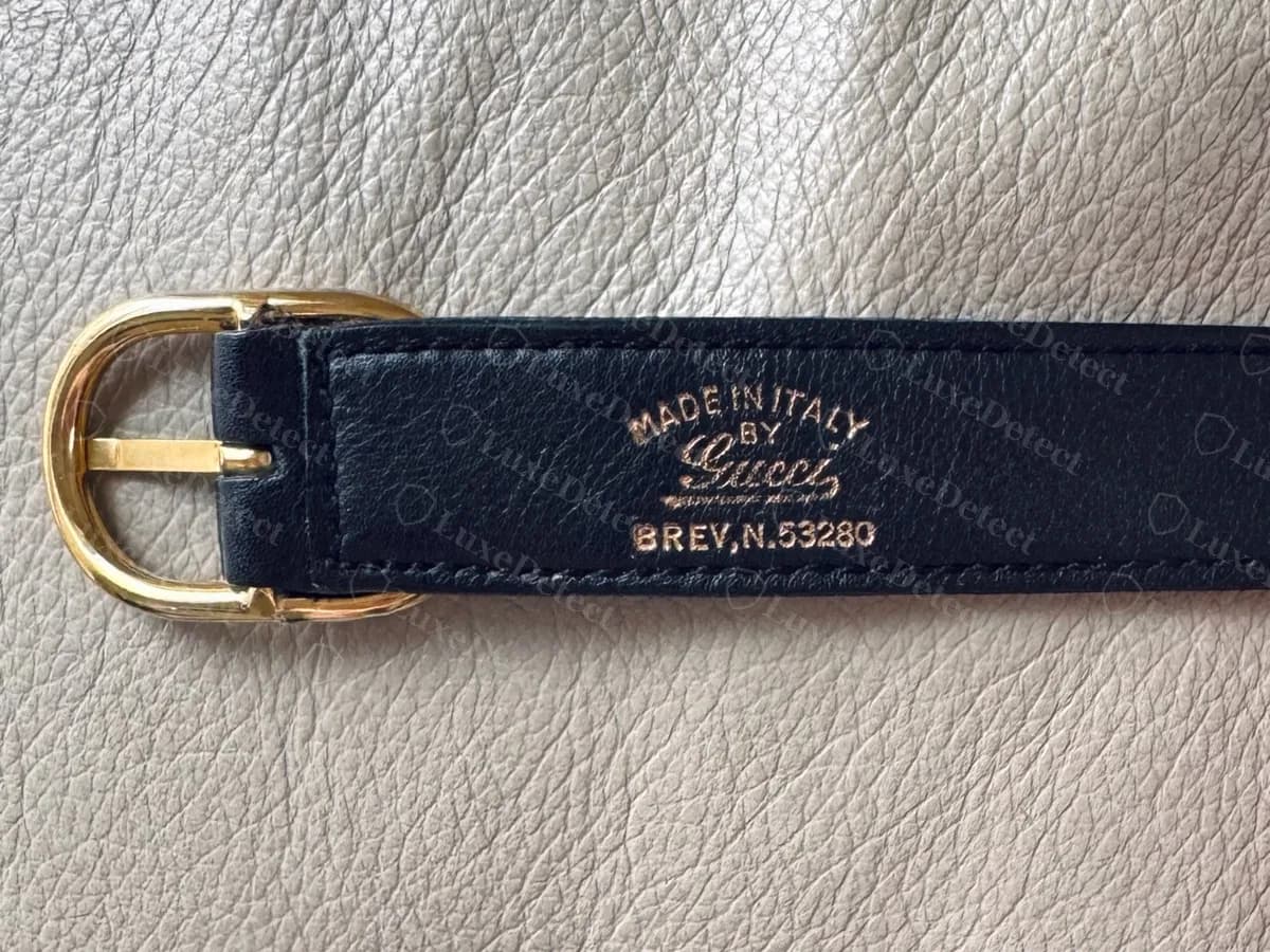 Genuine vintage Blondie strap underside stamped MADE IN ITALY BY Gucci with a script signature, and BREV. N. 53280 below, next to a gold-tone buckle