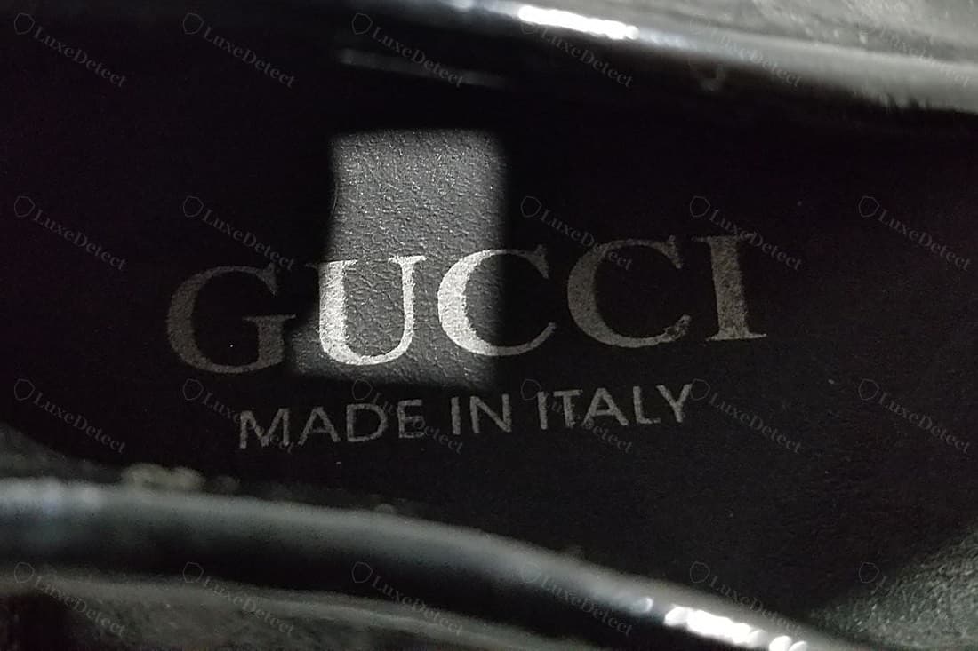 Counterfeit Gucci insole heat stamp — "MADE IN ITALY" set in capitals instead of lower case, the "GUCCI" serif thinner and higher-contrast with pinched letters