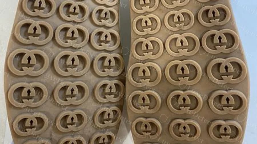Counterfeit Gucci Tennis 1977 platform sneakers: a tan sole covered in large round interlocking-GG discs, with no GUCCI panel in view