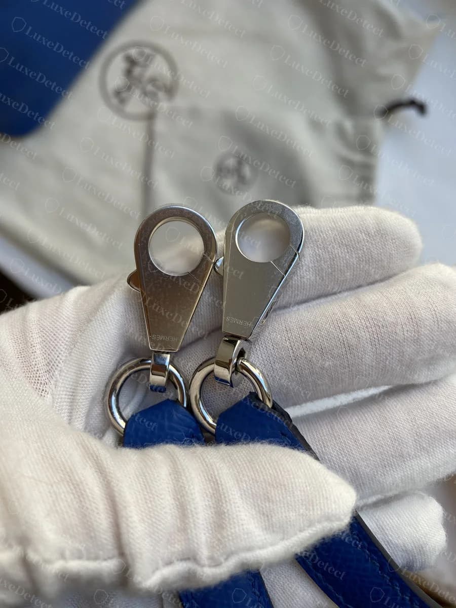 Hermès dust bag with the printed duc carriage logo, paired with a Bolide's twin hardware clips