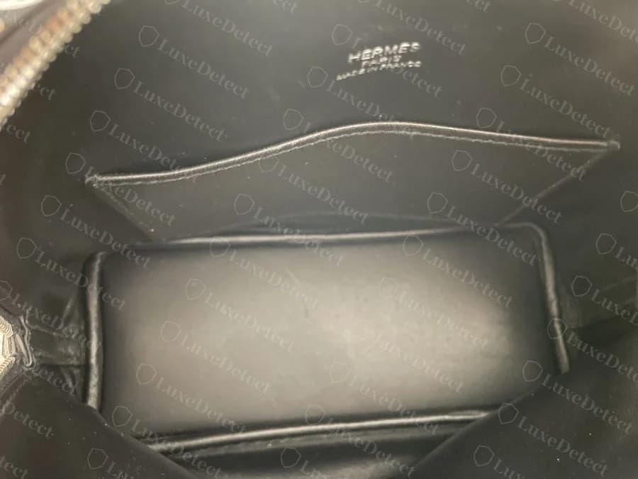 Hermès Bolide interior hot-stamp: HERMÈS PARIS MADE IN FRANCE centred above the interior pocket, gold foil on black lining