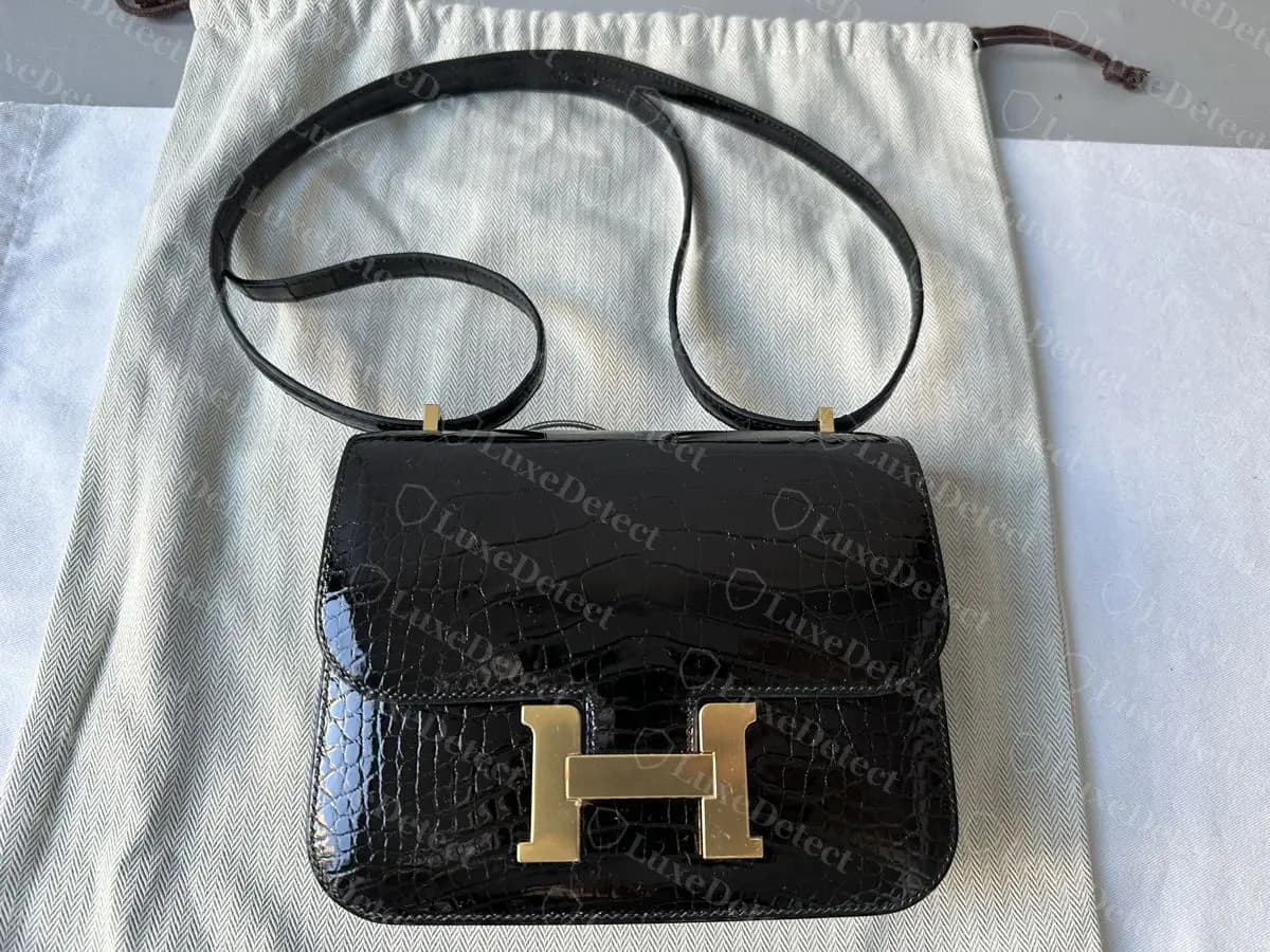 Genuine Hermès Constance 18 in shiny black alligator with gold hardware, the H clasp centred on the flap