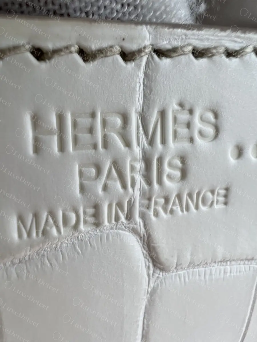 Blind (unfoiled) stamp on matte Himalaya Niloticus crocodile, the two-dot crocodile symbol to the right of HERMÈS