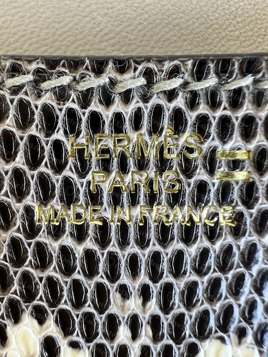 Gold-foil stamp on a lizard Constance, the lizard symbol to the right of HERMÈS and PARIS