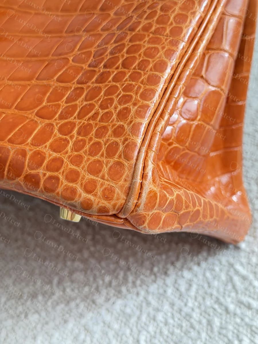Exotic-skin side panel corner seam showing consistent scale size and row direction continuing across the seam line
