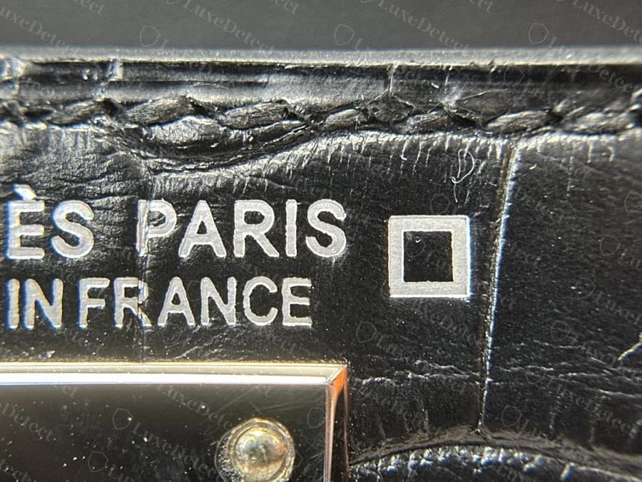 HERMÈS PARIS MADE IN FRANCE interior stamp on scaled alligator leather, the panel next to the stamp clearly showing genuine scale texture