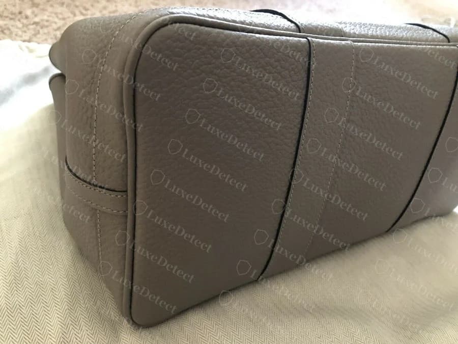 Genuine Garden Party base construction, showing the boxed corner seams and even saddle stitching that gives the bag its structure