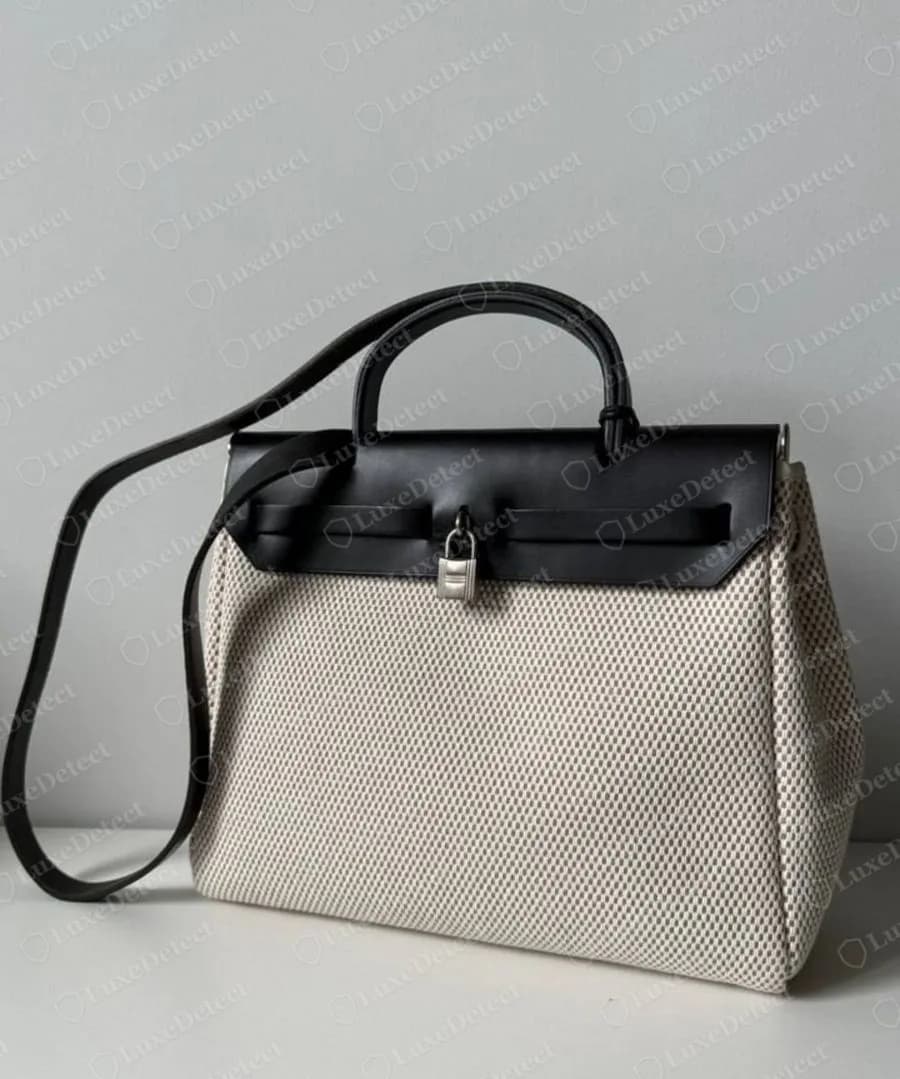 Authenticated older-generation Herbag from 2001, black leather flap and frame over a natural toile body, palladium cadena, no zip under the flap