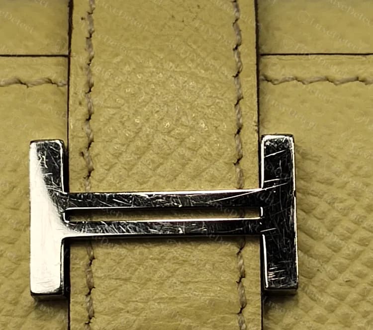 Genuine Béarn H clasp on a pale Epsom strap, hand-stitched, with wear on the silver-tone metal