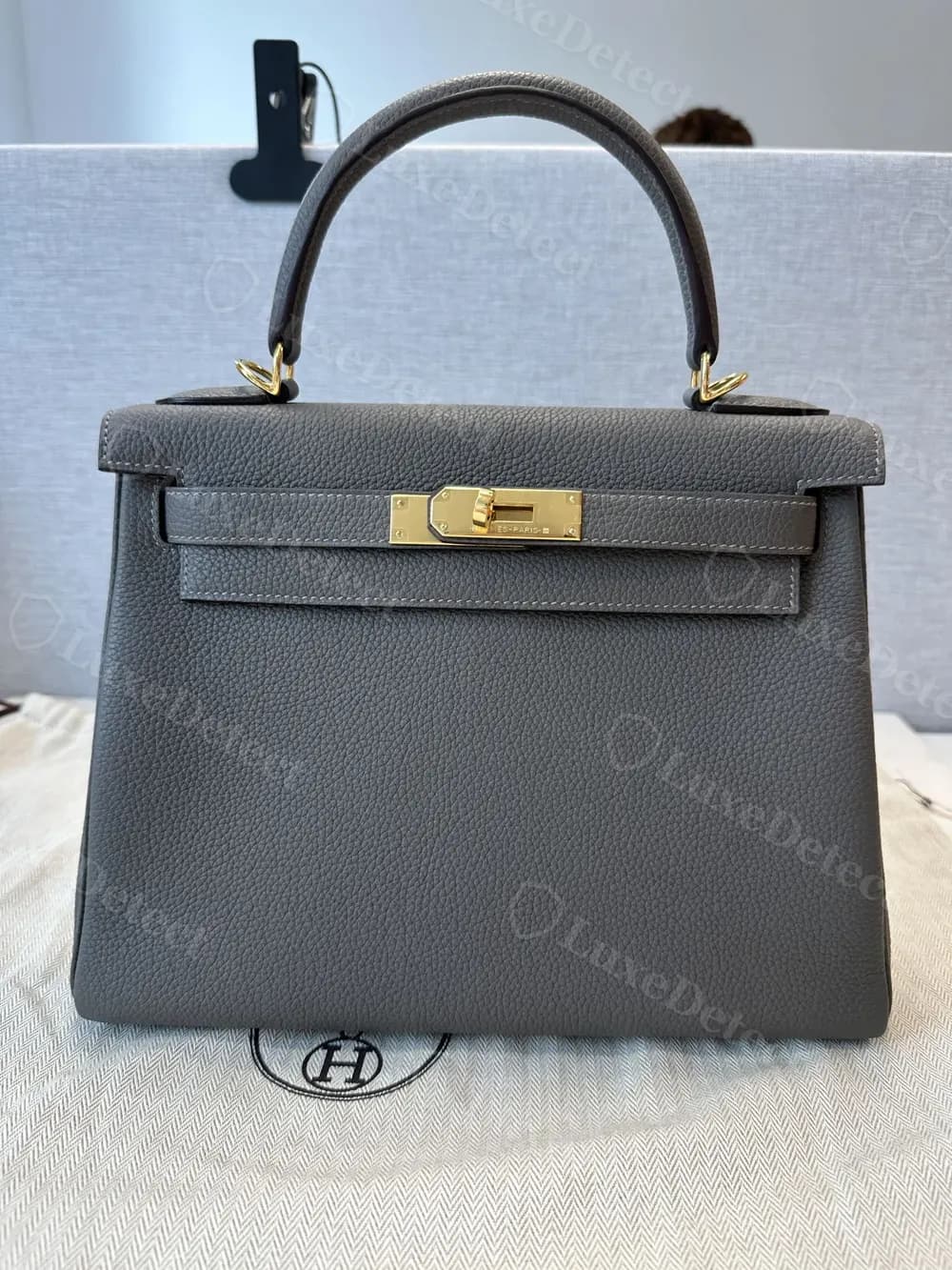 One of the more convincing counterfeit Kelly bags in our sample, correct proportions and hardware tone at full-bag distance, with the tells only visible up close