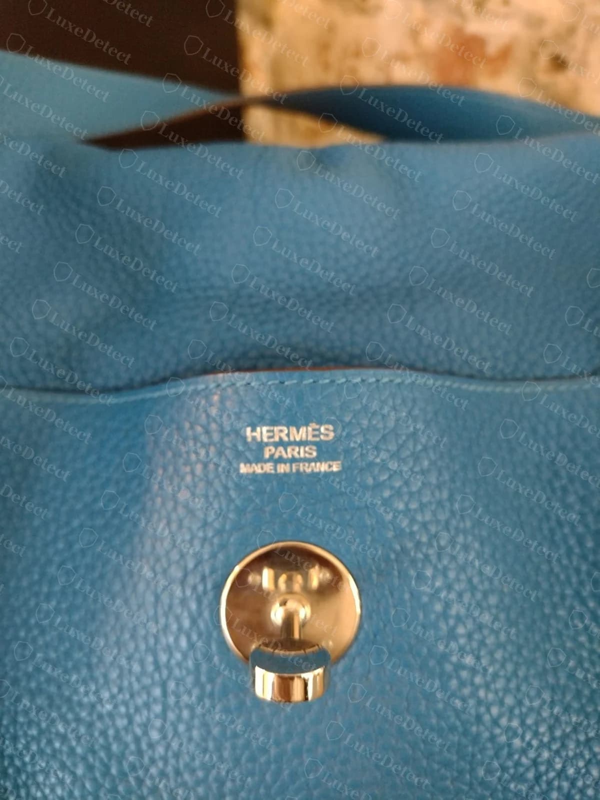 Genuine Hermès Lindy blind stamp and strap swivel clasp together, blue Clemence leather, showing the "HERMÈS PARIS MADE IN FRANCE" stamp evenly debossed near the clasp hardware